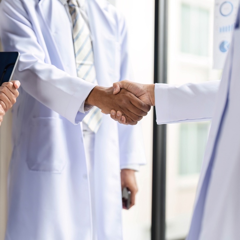 Healthcare Professionals Shaking Hands to Foster Collaboration